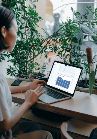 Professional woman stand sits at a desk working on