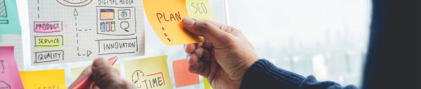 Person at Project Board banner